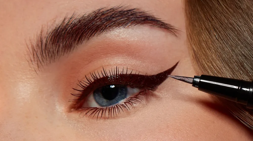 Woman applying winger eyeliner