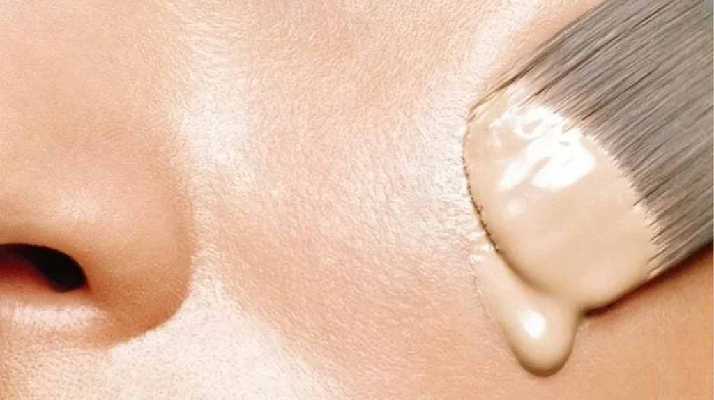 Woman applying foundation to her face