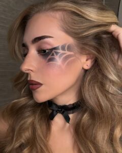 Side profile of the finished reverse spiderweb eye makeup with a black choker