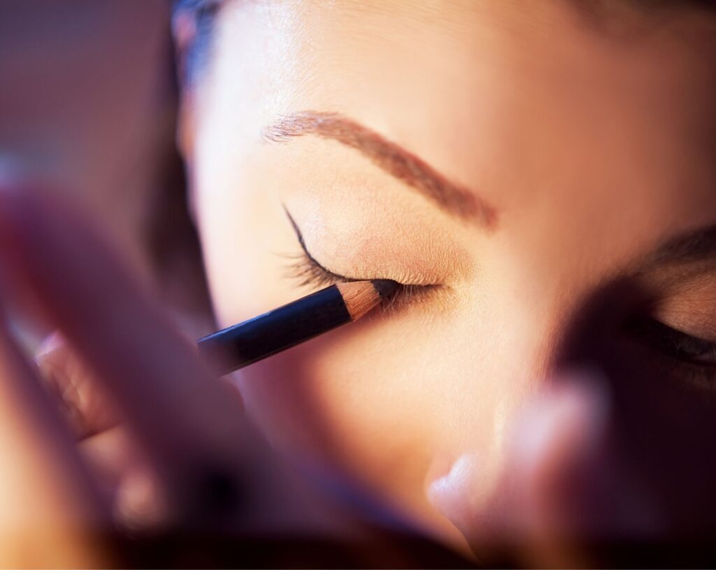 Drawing a short eyeliner flick outwards from the outer corner of the eye